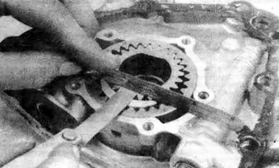 14.10е. Измерьте осевой люфт шестерни с помощью прямой линейки и плоского щупа