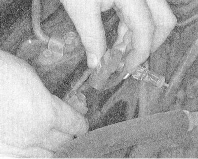 4. Осторожно поворачивая против часовой стрелки, извлеките из кожуха фары патрон с лампой..